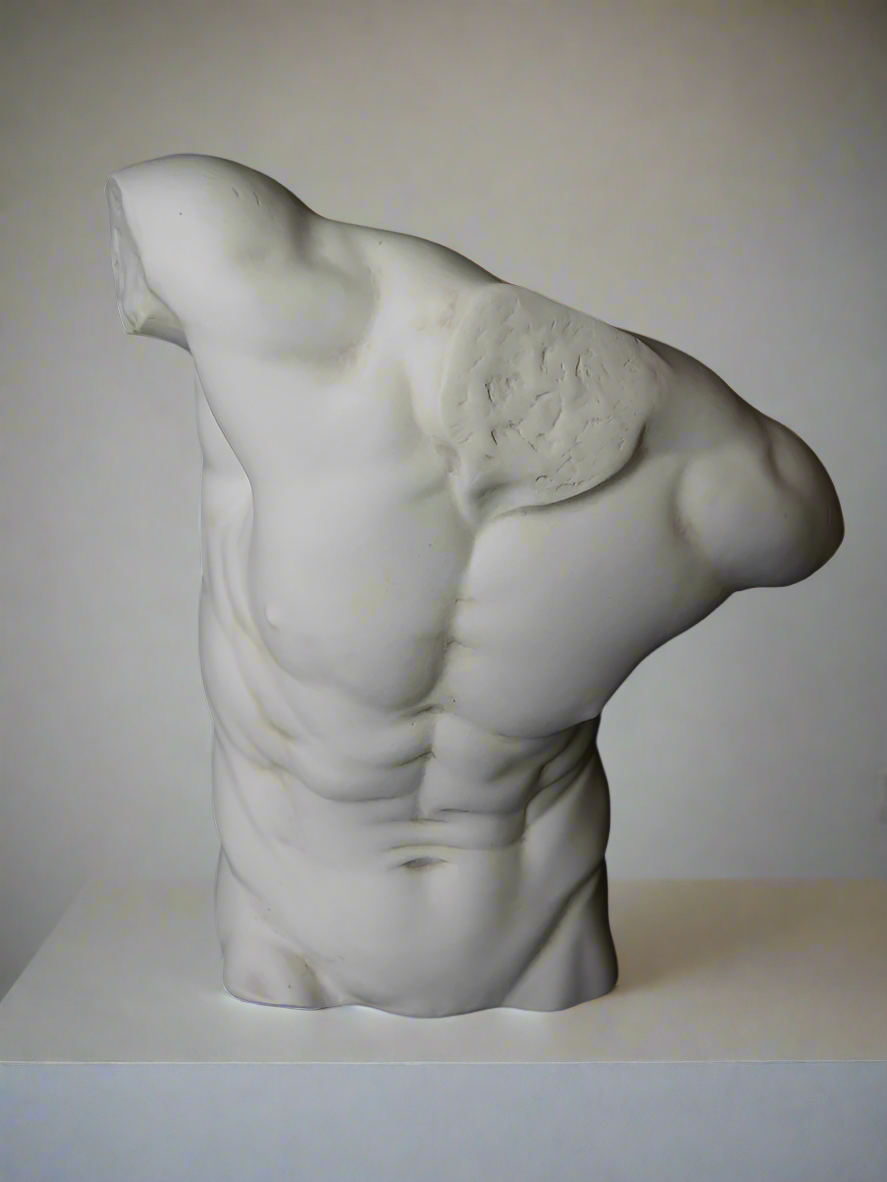 A sculpture of a large male torso made from marble, displayed against a black background.