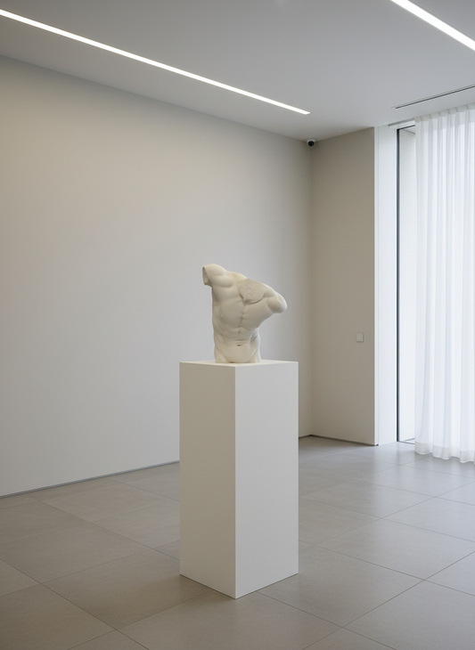 A sculpture of a large male torso made from marble, displayed against a black background.