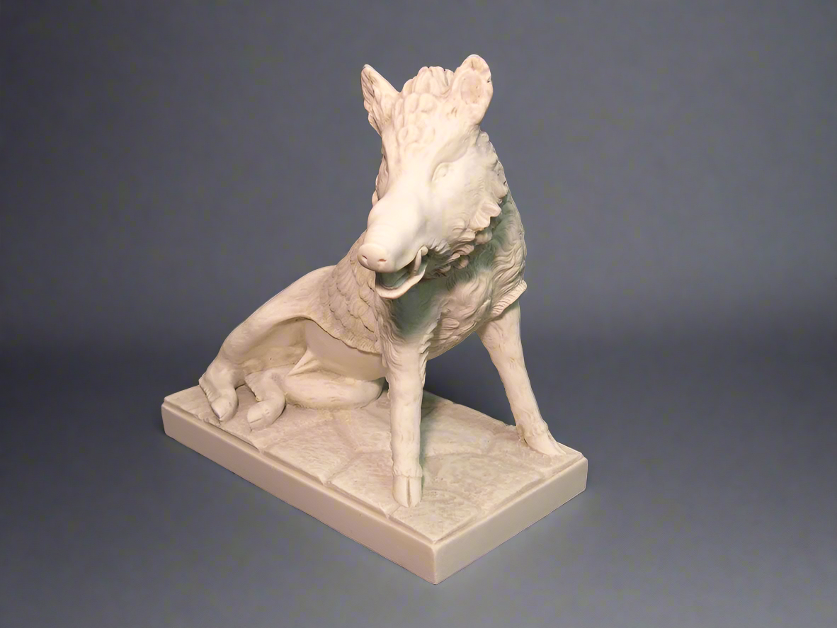 White stone sculpture of a dog on a gray background