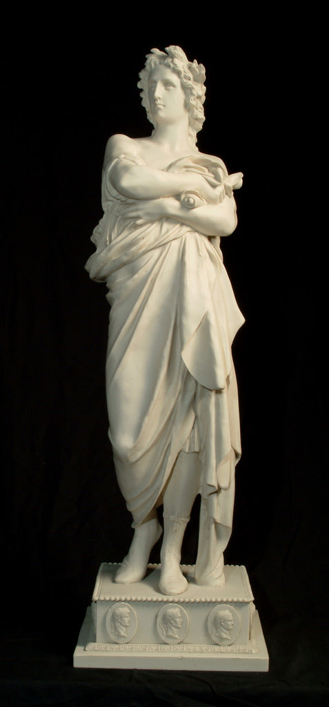 Marble sculpture of Julius Caesar in his robes of office, holding senate scrolls, and a laurel crown, with a decorated base featuring cameos of other Roman Emperors.