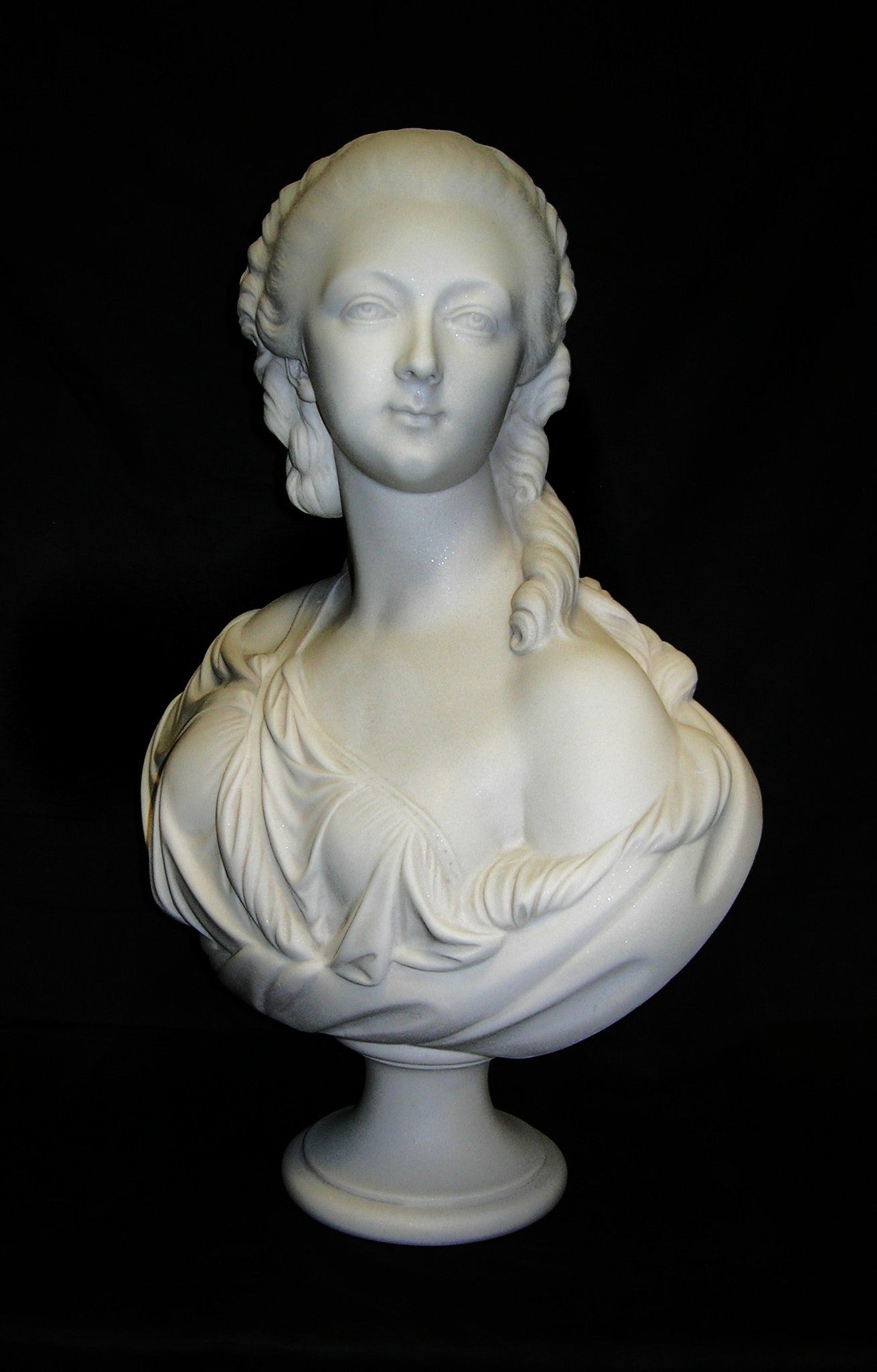 A marble bust sculpture of Madame du Barry with a blackened bronze finish, depicting a female figure with classical attire and hairstyle.