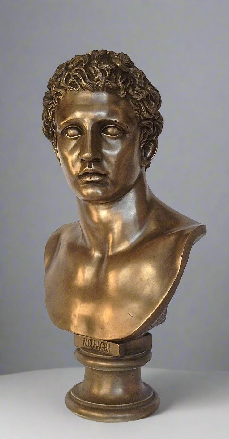 Bronze bust of a classical figure on a gray background