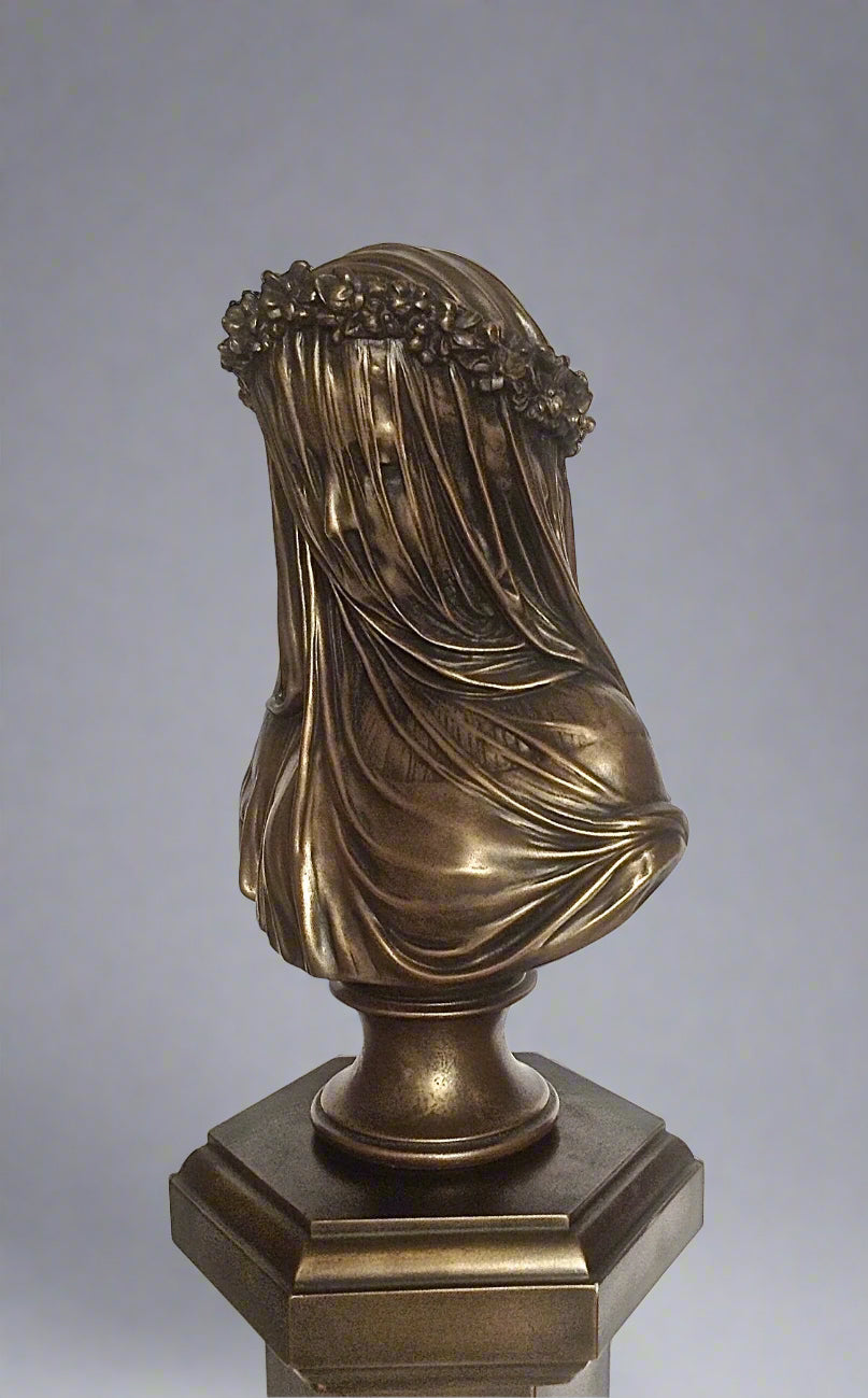 Bronze sculpture of a draped figure on a gray background