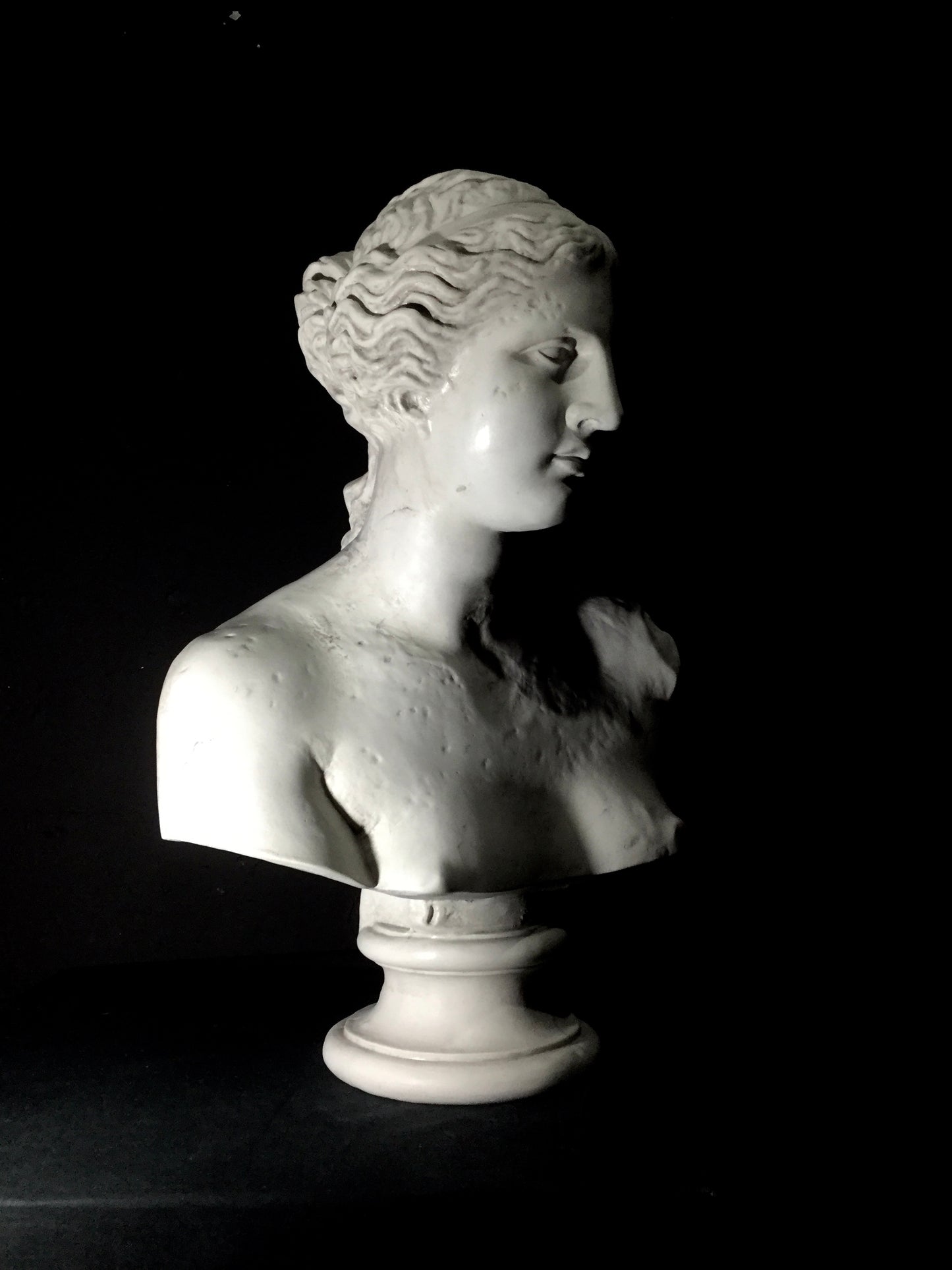 A white marble bust of Helen of Troy with a classical hairstyle and facial features.