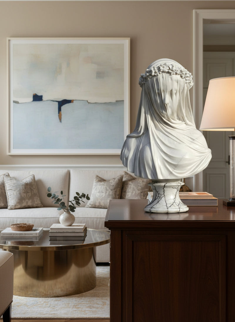 A marble bust known as 'The Veiled Lady' after the antique sculpture by Monti, 1875, with a polished Carrara marble finish on a white and black veined socle.