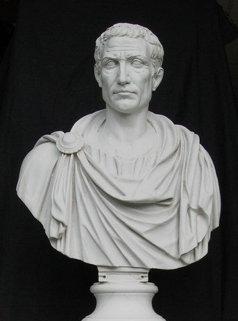 White marble bust of a classical figure against a black background