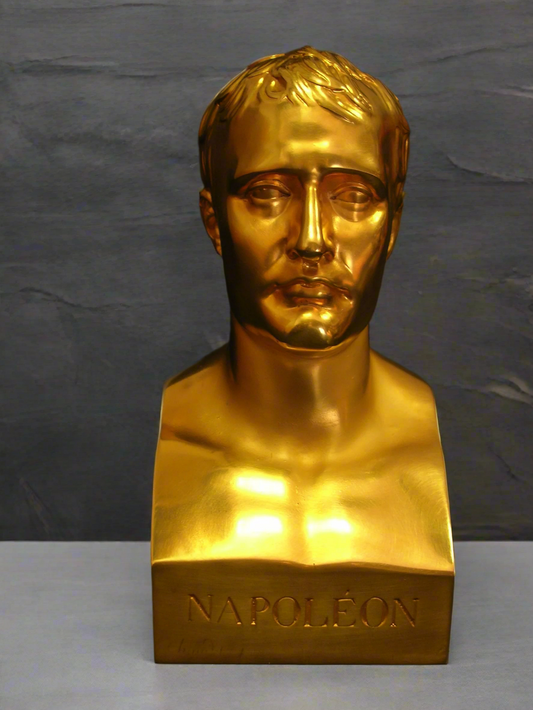 Gold bust of a historical figure on a gray background