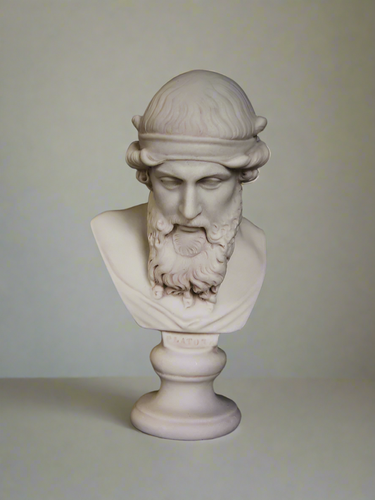 A white marble bust of Plato with a dark background.