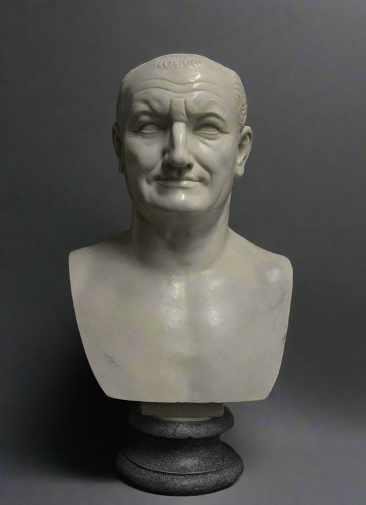 White marble bust of a Vespasian on a dark gray background