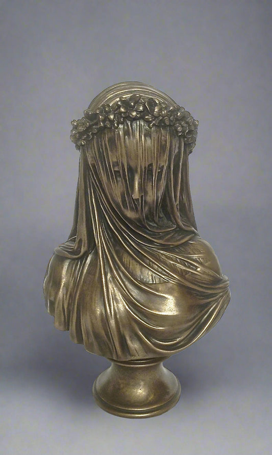 Bronze bust of a draped figure with floral crown on a gray background